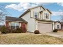 Two-story house with beige siding, red brick, and a two-car garage at 6354 River Run Dr, Indianapolis, IN 46221