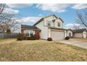 Two-story house with beige siding, red brick, and a two-car garage at 6354 River Run Dr, Indianapolis, IN 46221