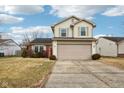 Two-story house with beige siding, red brick, and a two-car garage at 6354 River Run Dr, Indianapolis, IN 46221