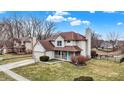 An exterior home view showcasing a well-maintained lawn and blue front door at 6530 Duck Pond Dr, Fishers, IN 46038