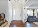 Inviting foyer with hardwood floors, white trim, and an open view into the adjacent living space at 6530 Duck Pond Dr, Fishers, IN 46038