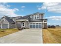 Gray two-story home with a two-car garage, stone accents, and well-maintained landscaping at 6781 Seattle Slew Dr, Whitestown, IN 46075