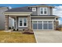Charming two-story home features gray siding, stone accents, and a two-car garage at 6781 Seattle Slew Dr, Whitestown, IN 46075
