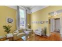 Living room with hardwood floors, yellow walls, and comfy seating at 714 Buchanan St # 5, Indianapolis, IN 46203