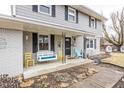 Inviting front porch with a swing and yellow chairs at 8139 Hi Vu Dr, Indianapolis, IN 46227