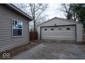 Detached two car garage with vinyl siding and an asphalt driveway at 8505 W Jackson St, Muncie, IN 47304