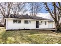Charming single-story home with white siding, black door, and an attached one car garage at 8815 Frontenac Rd, Indianapolis, IN 46226