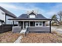 Gray house with white trim, front porch, and landscaping at 1058 N Holmes Ave, Indianapolis, IN 46222