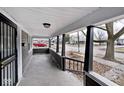 Covered porch with dark columns and street view at 1058 N Holmes Ave, Indianapolis, IN 46222