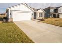 A charming single-story home features a spacious driveway and well-maintained front lawn at 1132 Fleming Dr, Greenfield, IN 46140
