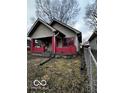 Side view of a one-story house with a chain link fence at 1154 N Belleview Pl, Indianapolis, IN 46222