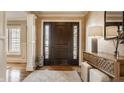 Elegant foyer with hardwood floors, stylish console table, and a welcoming ambiance at 1175 Princeton Pl, Zionsville, IN 46077