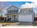 Two-story house with gray siding, white garage door, and landscaping at 14431 Cotton Blossom Dr, Fishers, IN 46038