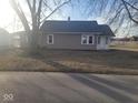Exterior view of this house from the front, with gray siding, front door, and trees at 1510 Josephine St, Martinsville, IN 46151