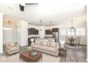 Bright and airy living room and kitchen area with modern furnishings, stainless appliances, and pendant lighting at 1555 W 151St St, Westfield, IN 46074