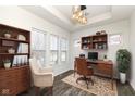 Well-lit home office features built-in shelves, a work desk, chair, and large windows for ample natural light at 1555 W 151St St, Westfield, IN 46074