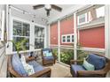 Relaxing screened porch with comfortable seating, string lights, and view of the backyard and garden at 1555 W 151St St, Westfield, IN 46074