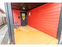 Inviting covered porch with black accents, bright yellow floor, and cozy seating area at 1705 Hoyt Ave, Indianapolis, IN 46203