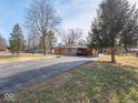 Ranch home with driveway and mature trees at 2325 Cardinal Dr, Indianapolis, IN 46227