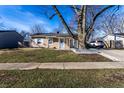 Lovely tan ranch home with neat landscaping, covered entry, and classic curb appeal at 3144 Voigt Dr, Indianapolis, IN 46224