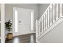 Bright entryway with hardwood floors, a staircase with white railing, and natural light, adding style and elegance at 33 N Highland Knoll Way, Bargersville, IN 46106