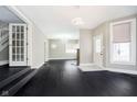 Spacious living room featuring dark wood floors, fresh neutral walls and new light fixtures at 602 N Harrison St, Alexandria, IN 46001