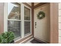 Front entry with a wreath, two windows, and a potted plant at 633 Cielo Vista Dr, Greenwood, IN 46143
