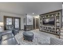Living room with leather furniture, fireplace, and built-in shelving at 633 Cielo Vista Dr, Greenwood, IN 46143