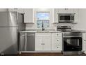 Updated kitchen with white cabinets, stainless steel appliances, and granite countertops at 633 S Grand Ave, Indianapolis, IN 46219