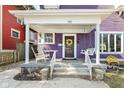Inviting front porch features a porch swing, seating, and a decorative wreath, enhancing curb appeal at 66 N Ritter Ave, Indianapolis, IN 46219