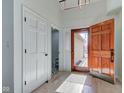Bright entryway with hardwood floors, a wooden front door, and white painted trim at 8349 Tequista Cir, Indianapolis, IN 46236