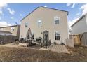 View of the backyard with a gravel area with outdoor seating, grill, and a grassy area at 9703 W Stargazer Dr, Pendleton, IN 46064