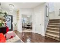 Welcoming foyer featuring hardwood floors, chandelier lighting, staircase, and glimpse of the formal dining room at 1006 Cherry Tree Ln, Greenwood, IN 46143