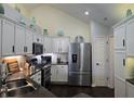 Bright kitchen with stainless steel appliances, granite countertops, and white cabinets at 1016 Laurelwood Ln # D, Greenwood, IN 46142