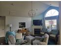 Spacious living room with a fireplace, vaulted ceiling, and large windows at 1016 Laurelwood Ln # D, Greenwood, IN 46142