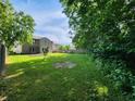 Spacious backyard featuring a garden bed, a lawn, and privacy fence at 12899 Star Dr, Fishers, IN 46037