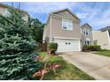 Well-maintained two-story house featuring a garage and manicured bushes at 12899 Star Dr, Fishers, IN 46037