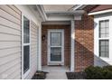 Inviting front entrance with brick accents and a storm door at 13998 Avalon Blvd, Fishers, IN 46037