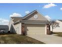 Attached two-car garage with brick facade and siding, offering convenient parking at 13998 Avalon Blvd, Fishers, IN 46037
