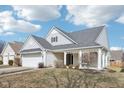 Charming single-story home with an attached garage and quaint front porch at 15104 Smithfield Dr, Westfield, IN 46074