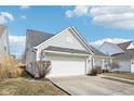 Charming single-story home featuring a paved driveway and an attached two-car garage at 15104 Smithfield Dr, Westfield, IN 46074
