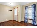 Light and airy entryway with hardwood floors, a coat rack and a window with patterned blue curtains at 1563 Old Thicket Ct, Greenwood, IN 46143