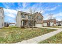 Street view of a brick and tan two-story home with well manicured lawn and sidewalk at 1563 Old Thicket Ct, Greenwood, IN 46143
