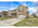 Charming two-story brick and tan home with attached two car garage and large driveway in residential area at 1563 Old Thicket Ct, Greenwood, IN 46143