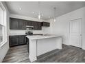 Modern kitchen features an island with white marble countertop and stainless steel appliances at 1934 Black Oak Dr, Shelbyville, IN 46176