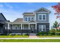 Charming two-story home with gray siding, brick accents, and a welcoming front porch at 19997 Old Dock Rd, Westfield, IN 46074