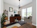 Bright home office featuring modern desk, chair, decor, and natural light from large window at 19997 Old Dock Rd, Westfield, IN 46074