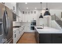Modern kitchen with white cabinetry, quartz countertops, stainless steel appliances, and a large island at 19997 Old Dock Rd, Westfield, IN 46074