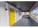 Inviting porch with bright yellow front door, stylish lighting, and a sheltered entrance at 218 W 31St St, Indianapolis, IN 46208