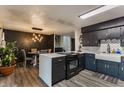 Well-appointed kitchen showcasing a breakfast bar, modern appliances, dining area and stylish accent wall at 362 1400 N, Summitville, IN 46070
